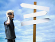 man looking at road sign