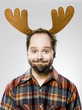 man in a plaid shirt wearing antlers