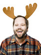 man in a plaid shirt wearing antlers