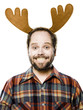 man in a plaid shirt wearing antlers