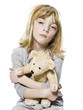 girl hugging her teddy bear