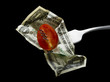 tomato and dollar on a fork