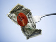 tomato and dollar on a fork