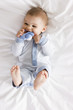 baby boy lying on a bed