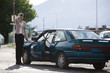 woman standing by her car after an accident