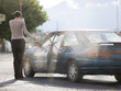 woman standing by her car after an accident