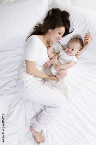Photo: mother and baby in bed mother and baby in bed