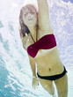 teenage girl in a bathing suit swimming in a pool