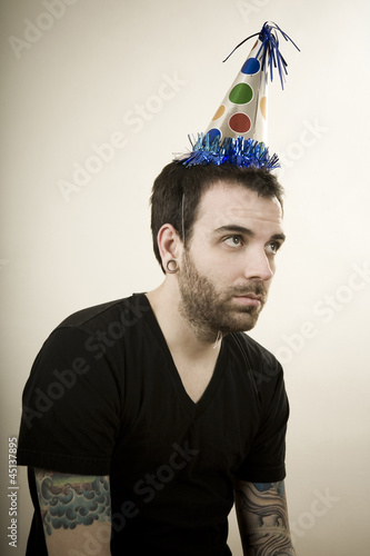 Photo: man wearing a party hat looking very depressed man wearing a party hat looking very depressed
