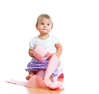 funny baby sitting on chamber pot with toilet paper roll