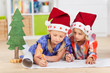 zwei kinder schreiben wunschzettel an das christkind