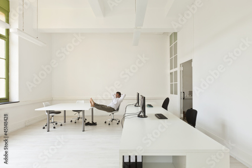 Photo: interior, office with modern furniture, man relaxes interior, office with modern furniture, man relaxes