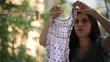 Young Adult Woman Hangs Laundry Clothes on Line to Dry