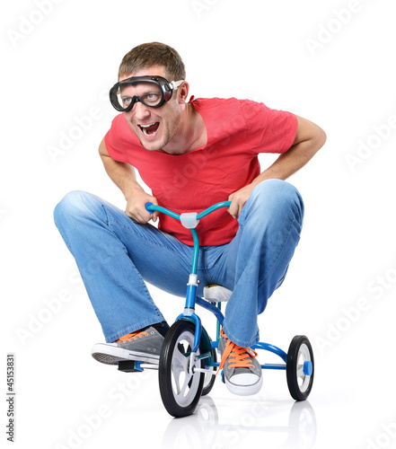 Photo: The curious man on a children's bicycle, on white background The curious man on a children's bicycle, on white background