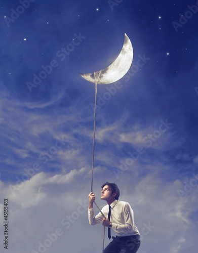 Photo: Businessman Holding the Moon Businessman Holding the Moon