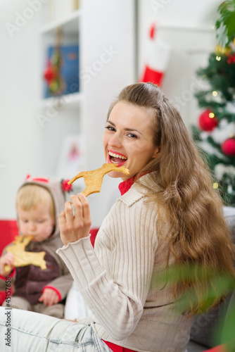 Photo: Mother and baby eating Christmas deer shaped cookies Mother and baby eating Christmas deer shaped cookies