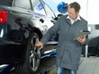 Master mechanic in a garage working with touchpad