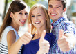 Young people with thumbs up