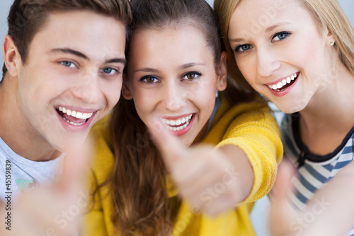 Photo: Three young friends with thumbs up Three young friends with thumbs up
