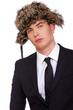 A man wearing a black suit and a fur hat