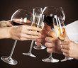 People holding glasses of white wine making a toast