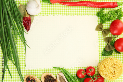 Photo: paper for recipes,vegetables and spices on green background paper for recipes,vegetables and spices on green background
