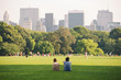 People enjoying relaxing outdoors in Central Park, NYC.