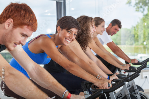 Photo: Group of People Cycling at Gym Group of People Cycling at Gym