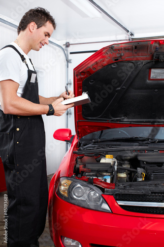 Photo: Professional auto mechanic. Professional auto mechanic.