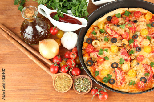Photo: colorful composition of delicious pizza, vegetables and spices colorful composition of delicious pizza, vegetables and spices