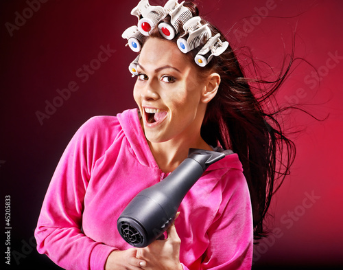 Photo: Woman wear hair curlers on head. Woman wear hair curlers on head.