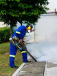 unidentified worker fogging for dengue control