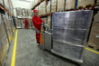 Two workers in uniforms  working in storehouse