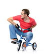 Cool man in glasses on a children's bicycle, white background
