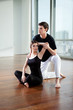 Yoga Instructor Assisting Woman