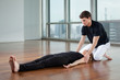 Yoga Instructor Assisting Woman At Gym