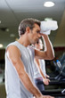 Man Wiping Sweat With Towel At Health Club
