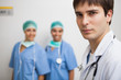 Satisfied doctor with two nurses