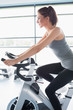 Woman riding an exercise bike