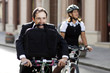Businessman and woman on bicycle