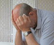 Depressed man holding tissue