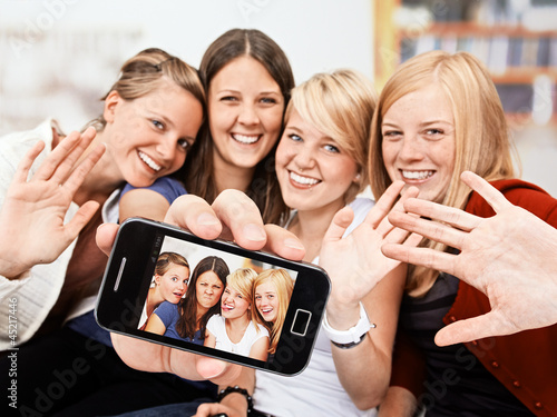 Photo: 4 girls with self-portait on the smartphone 4 girls with self-portait on the smartphone