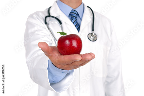 Photo: Doctor holding apple Doctor holding apple