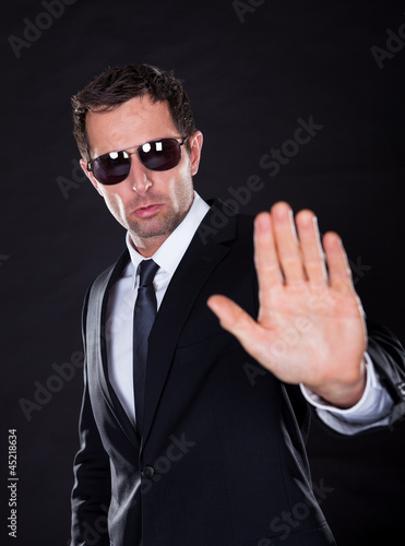 Photo: Portrait Of Young Man Making Stop Gesture Portrait Of Young Man Making Stop Gesture