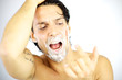 Photo: Handsome man shouting with blood on his face after shaving Handsome man shouting with blood on his face after shaving