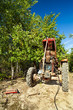 Photo: Senior farmer repairing his tractor Senior farmer repairing his tractor