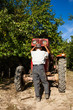 Photo: Senior farmer repairing his tractor Senior farmer repairing his tractor