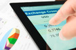 Hand on screen tablet pc with business information