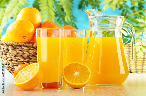 Photo: Composition with two glasses of orange juice and fruits Composition with two glasses of orange juice and fruits