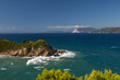 Rocky cape surrounded by sea waves